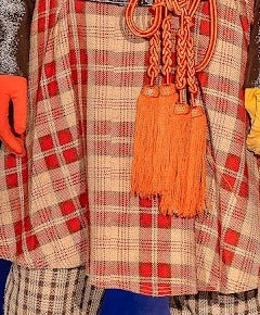 Orange tassel rope belt with braided knots and long tassel ends
